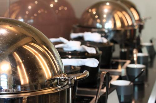 a kitchen with a row of pots and pans at Lancemore Mansion Hotel Werribee Park in Werribee