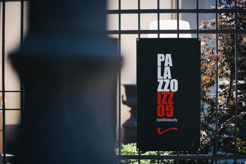 a black sign in front of a window at Palazzo Gozzi Bed & Beauty in Parma