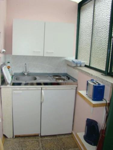 a small kitchen with a sink and a counter at Ferienunterkuenfte Schulz in Ahlbeck