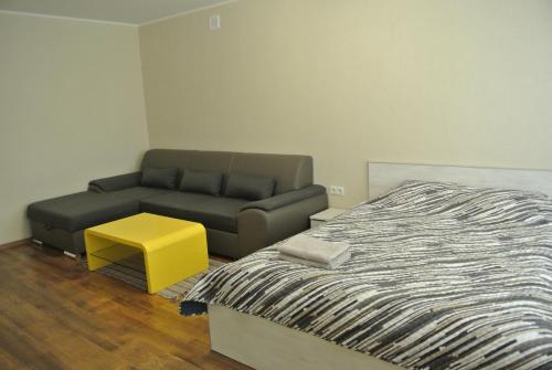 a living room with a bed and a couch at Piramida Apartments in Narva