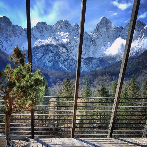 a view of a mountain range from a balcony at Špik Alpine Resort in Kranjska Gora