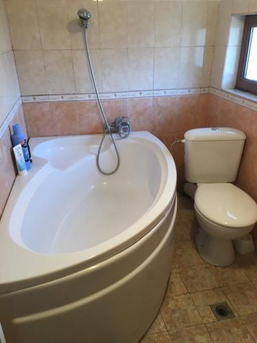 a bathroom with a white tub and a toilet at Art Studio in Sapareva Banya
