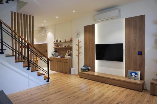 a living room with a flat screen tv on a wall at Ecology River in Dongshan