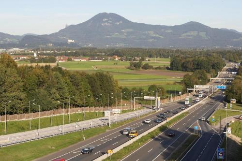 a highway with cars on it with mountains in the background at Best Western Hotel am Walserberg in Wals