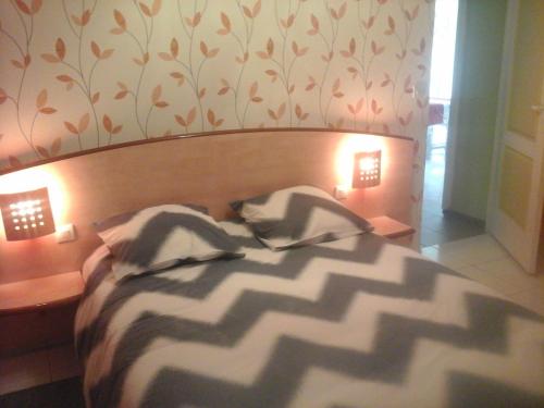a bedroom with a large bed with lights on it at gîte vacances in Moncontour
