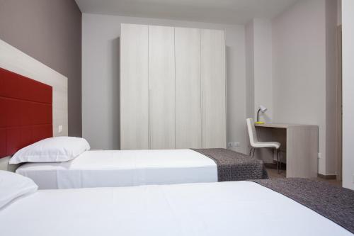 Ένα ή περισσότερα κρεβάτια σε δωμάτιο στο Astoria Suite Apartments