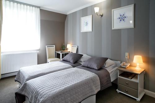 Postel nebo postele na pokoji v ubytování Hotel Niedźwiadek