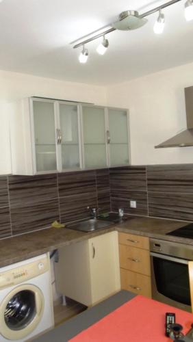 a kitchen with a sink and a washing machine at Villa Monche in Balchik
