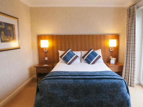 a hotel room with a large bed with two pillows at Harbour Heights Hotel in Poole