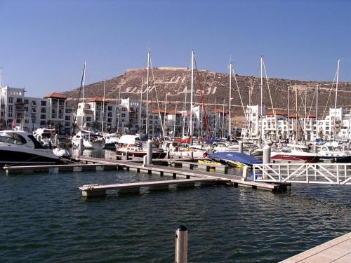 a marina with boats in the water and buildings at Appartement Luxe Marina Agadir in Agadir