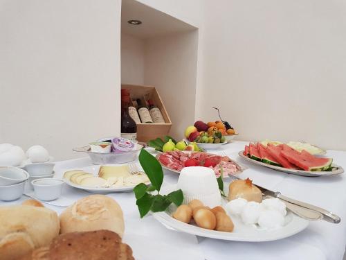 a table with many plates of food on it at Antica Masseria Torre Mozza in Torre Santa Susanna