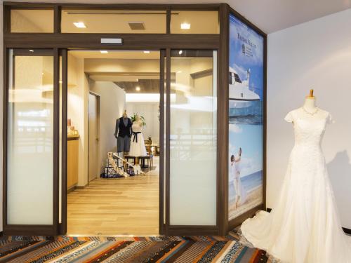 a dressing room with a mannequin and a wedding dress on display at Sheraton Okinawa Sunmarina Resort in Onna