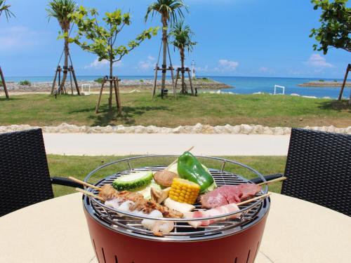 a barbecue grill with meat and vegetables on a table at Sheraton Okinawa Sunmarina Resort in Onna