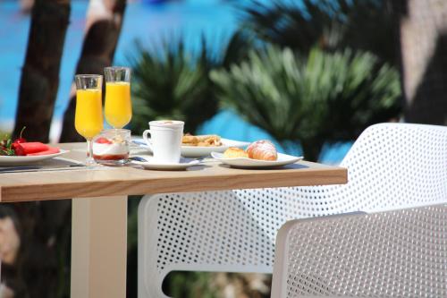a table topped with plates of food and drinks at Iberostar Málaga Playa in Torrox Costa