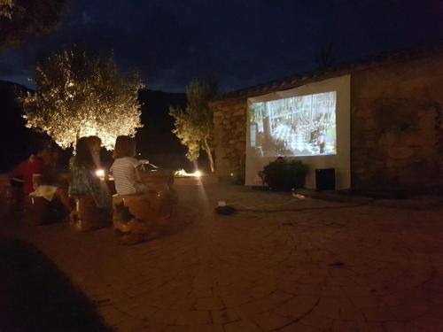 a group of people watching a movie at night at Mas del Sord 1335 in La Selva del Camp