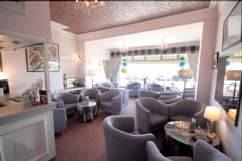 a waiting room with chairs and tables and a salon at The Paragon - Guest Accommodation in Scarborough