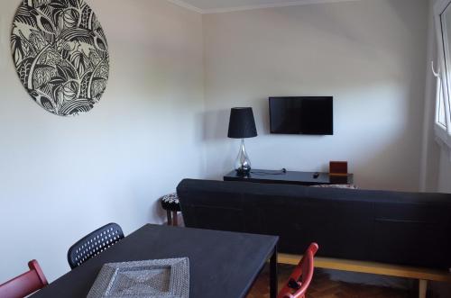 a living room with a couch and a tv at Lisbon Beach Apartments 3 in Costa da Caparica