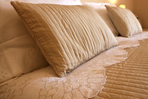 a bed with a pillow on top of it at Convento di San Colombo in Santo Stefano di Sessanio