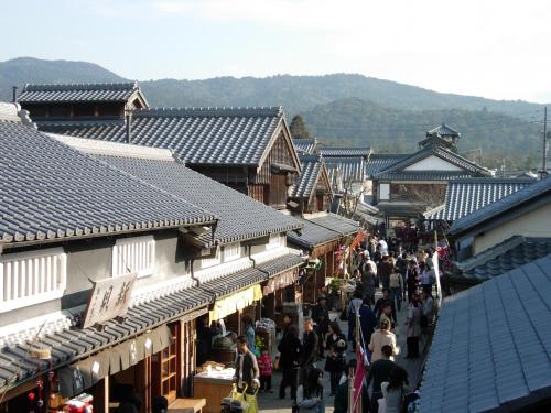 a crowd of people walking down a street in an old town at Tabinoyado Ushionoakari Geiboso in Shima