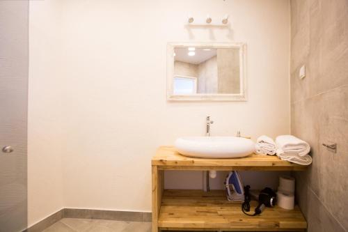 a bathroom with a sink and a mirror at Haapsalu Old Town Apartments in Haapsalu
