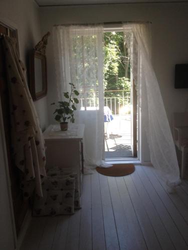 a white bath tub sitting under a window in a room at B&B Åvägen in Åhus