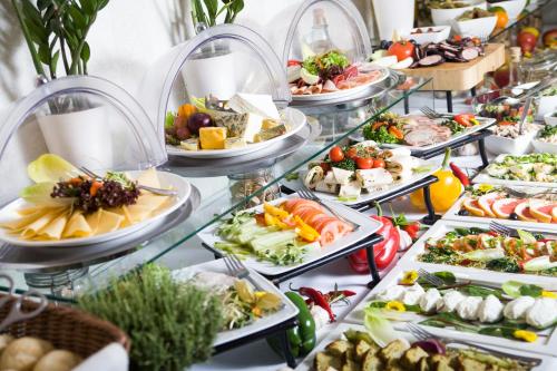 a buffet line with many plates of food at Hotel Bonum Old Town in Gdańsk
