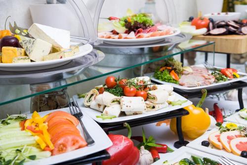 a buffet with many plates of food on display at Hotel Bonum Old Town in Gdańsk