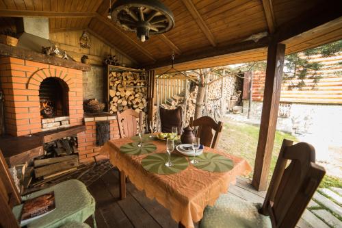 a dining room with a table and a fireplace at Pryvitannya Sontsyu in Skhidnitsa