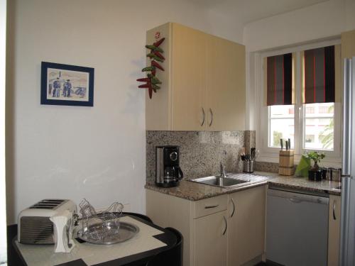 a kitchen with a sink and a counter top at IBERIA 1 appartement T3 à 200 m de la plage avec parking privé in Hendaye