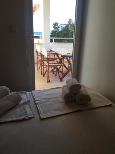 two towels on a bed with a view of a patio at Apartment Jadranka in Novalja