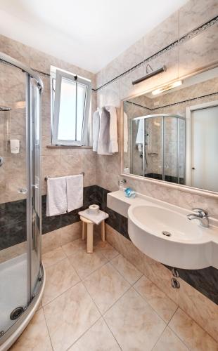 a bathroom with a sink and a shower at Hotel Bahia in San Benedetto del Tronto