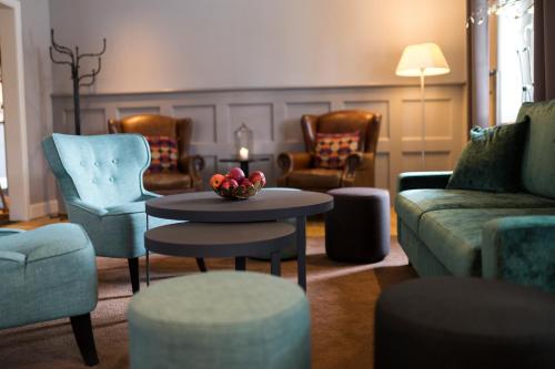 a living room with a couch and a table and chairs at Home Hotel Uman in Umeå