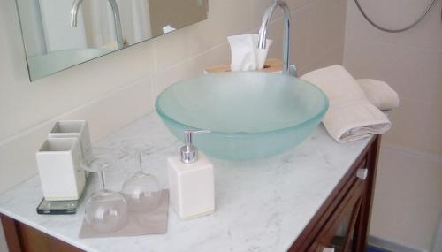 a bathroom with a blue bowl sink on a counter at Wohnen im Burghotel in Lorch am Rhein