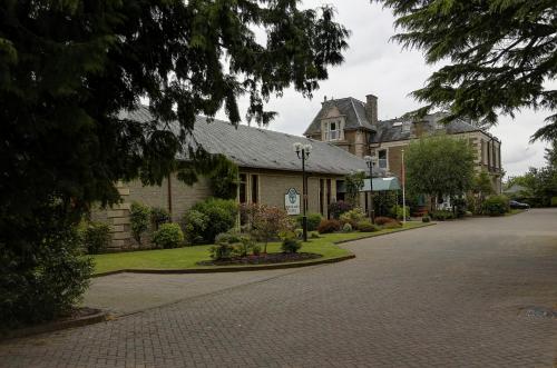 a house on a street with a driveway at Woodlands Hotel, BW Signature Collection in Dundee