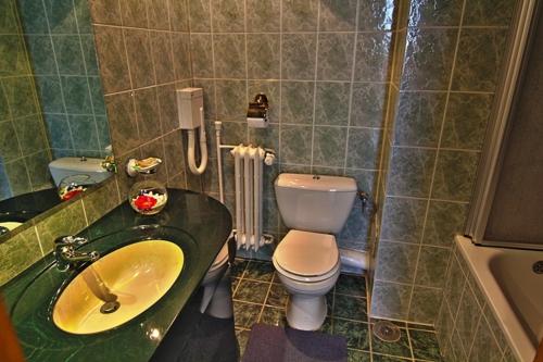 a bathroom with a sink and a toilet in it at Hotel Star in Piteşti