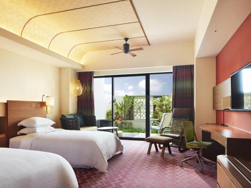 a hotel room with two beds and a flat screen tv at Sheraton Okinawa Sunmarina Resort in Onna