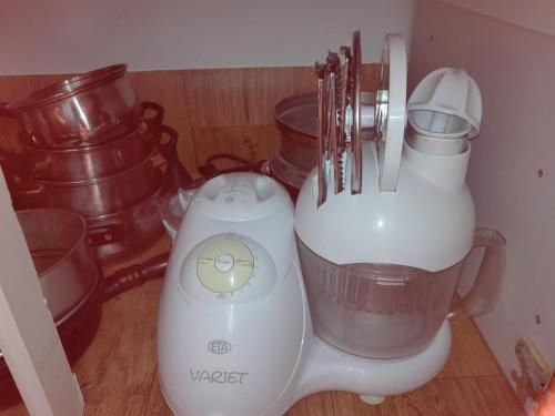 a blender sitting on a counter with some utensils at Orange Loft Apartment in Kájov