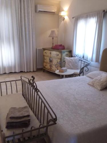 a bedroom with a bed and a living room at Villa Pardonise- Puglia-Salento-Casa vacanze in Diso