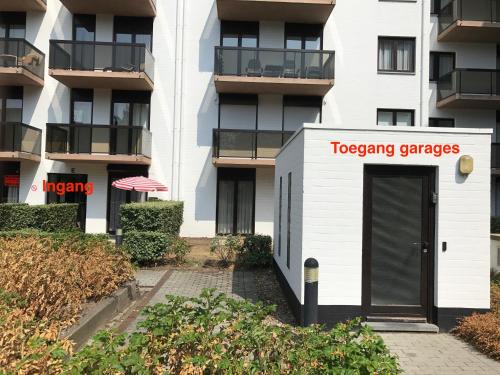a building with a sign that reads tocaping changes at Recent vernieuwd appartement met zeezicht en een gratis parkeerplaats in Koksijde