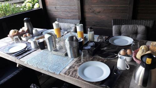 a table with plates of food and eggs on it at Bed & Breakfast De Schans in Makkum