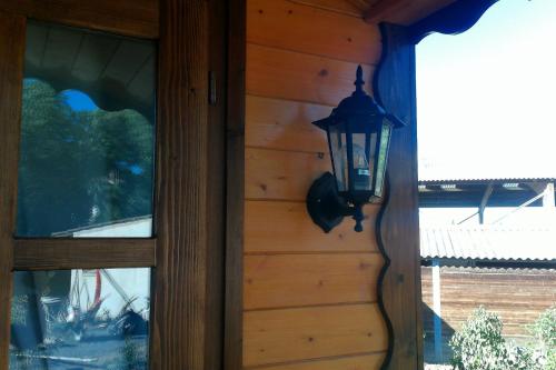 a lantern hanging on the side of a house at Les Gites De La Serre in Saint-Thibéry