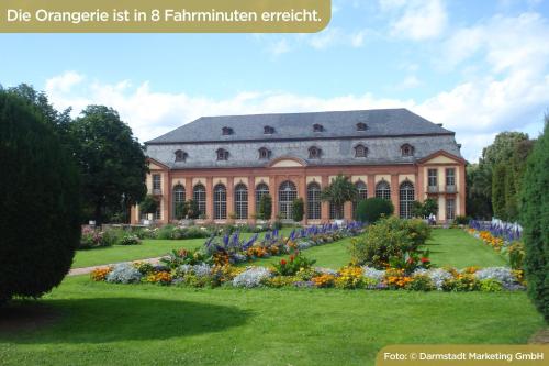 a large building with a garden in front of it at Best Western Plus Plaza Hotel Darmstadt in Darmstadt