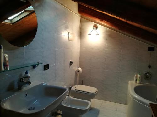 a bathroom with a white toilet and a sink at Casa Maia in Padova
