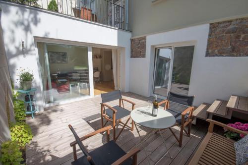 a patio with a table and chairs on a deck at Bed&Breakfast & Apartment Klafé in Brno