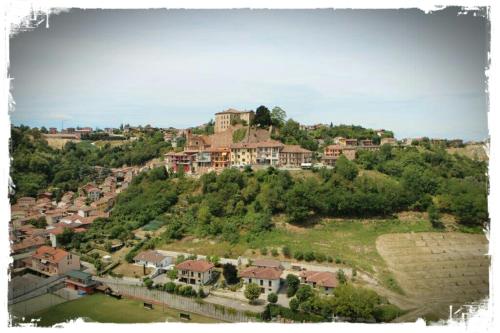 a village on top of a hill with houses at Il Borgo B&B in Castellinaldo