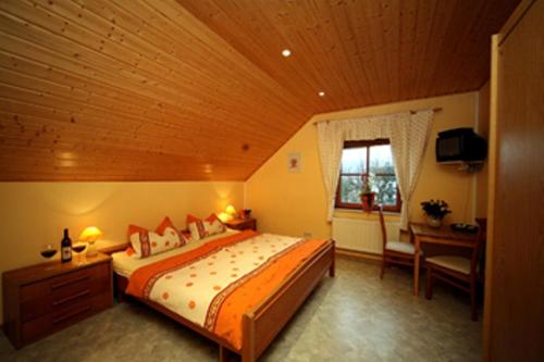 a bedroom with a large bed with a wooden ceiling at Weingut Berweiler in Klüsserath