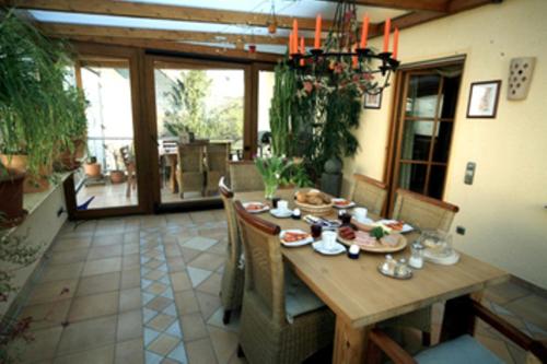 a wooden table in a room with a dining room at Ferienweingut Reh in Klüsserath in Klüsserath