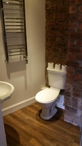 a bathroom with a white toilet and a sink at Royal Mile Balconies by the Castle in Edinburgh
