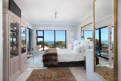 a bedroom with a bed and a view of the ocean at The Nantucket in Hermanus