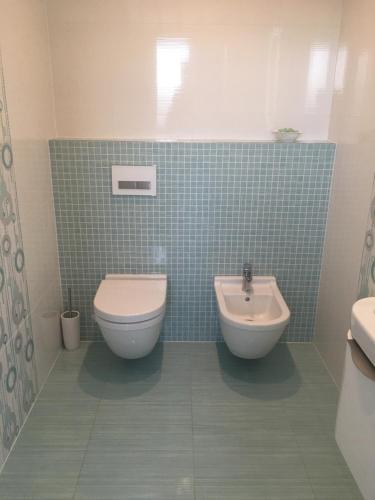 a bathroom with a toilet and a sink at AZ Tower Apartment in Brno